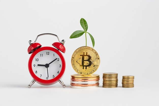 bitcoin piles next to alarm clock