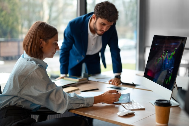 people in the office analyzing and checking finance graphs