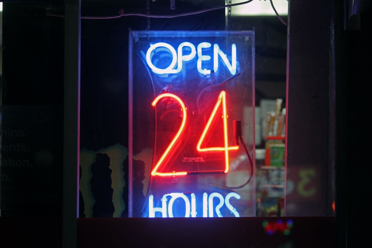CoinDesk’s header image (neon ‘Open 24 Hours’) illustrating the 24/7 trading and settlement ambition for Metaplanet’s bitcoin‑backed digital credit study — useful as a visual shorthand for the project’s around‑the‑clock market goal.